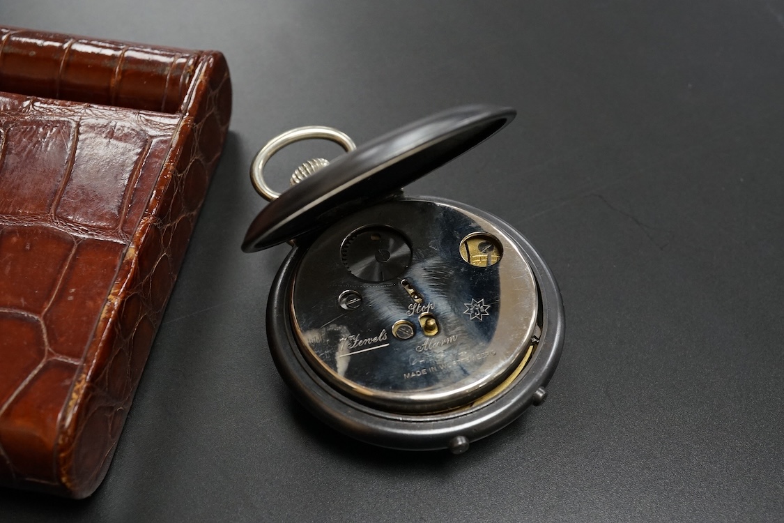 A Finnegan's leather cased travelling timepiece and a base metal Glow Worm pocket watch.